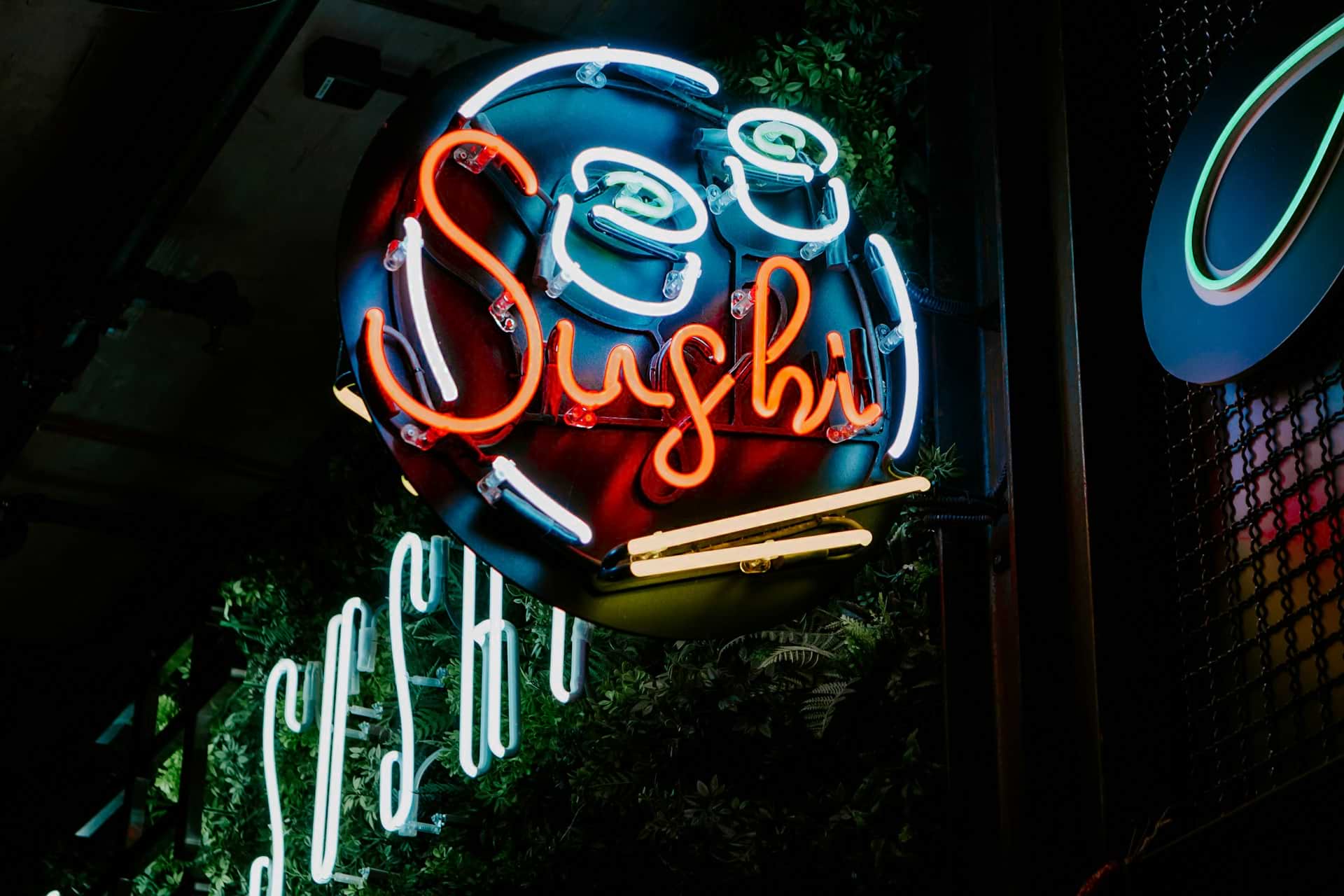 Neon welcome sign for a sushi restaurant. Source: Unsplash.