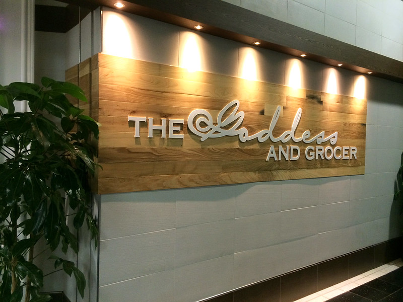 Wooden panel sign with raised aluminum letters