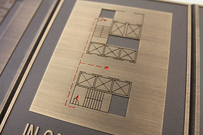 Etched bronze plaque displaying a fire exit plan 