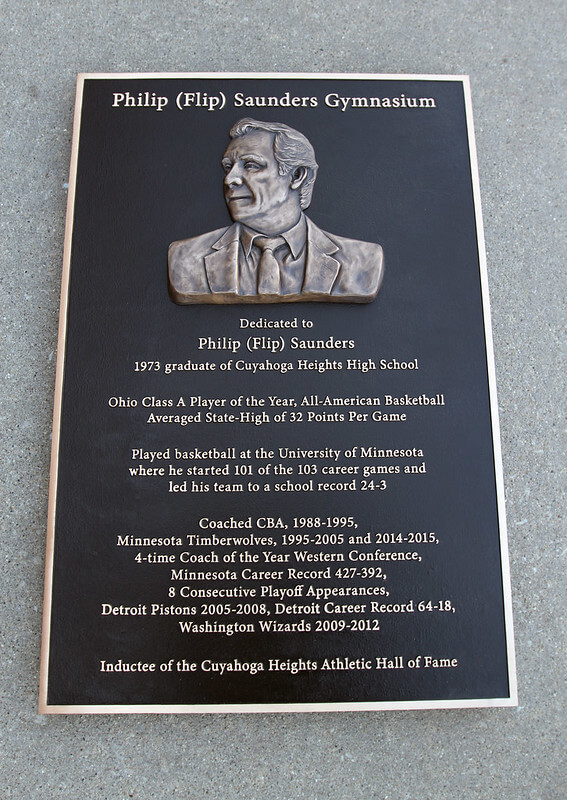 Bronze memorial plaque dedication in a high school gymnasium 