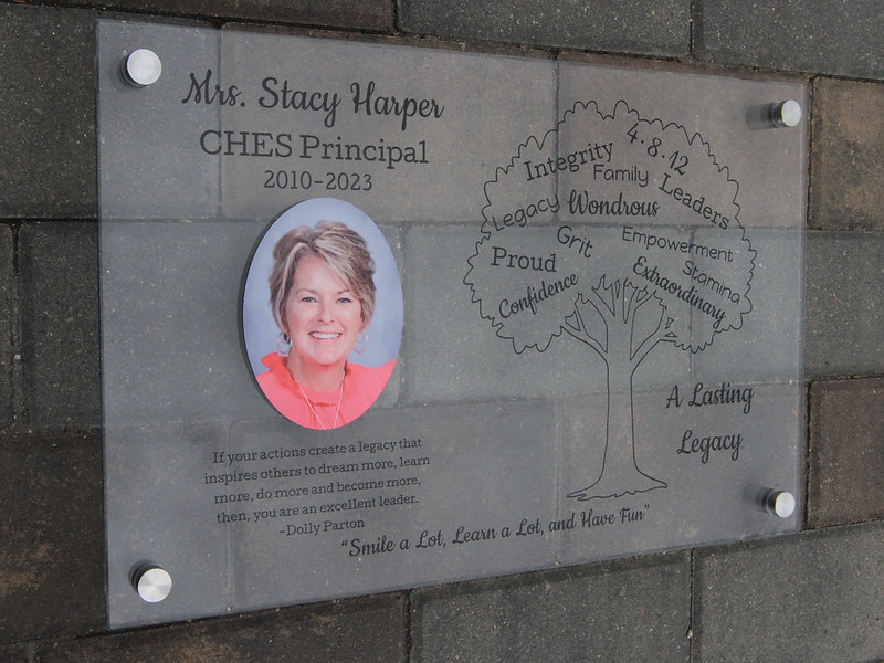 Glass plaque dedicating a legacy to a popular principal